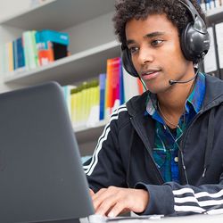 decorative picture: student with headset learning online