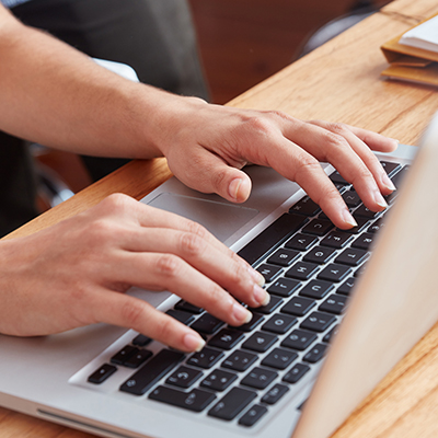 decorative picture: laptop with hands on the keyboard